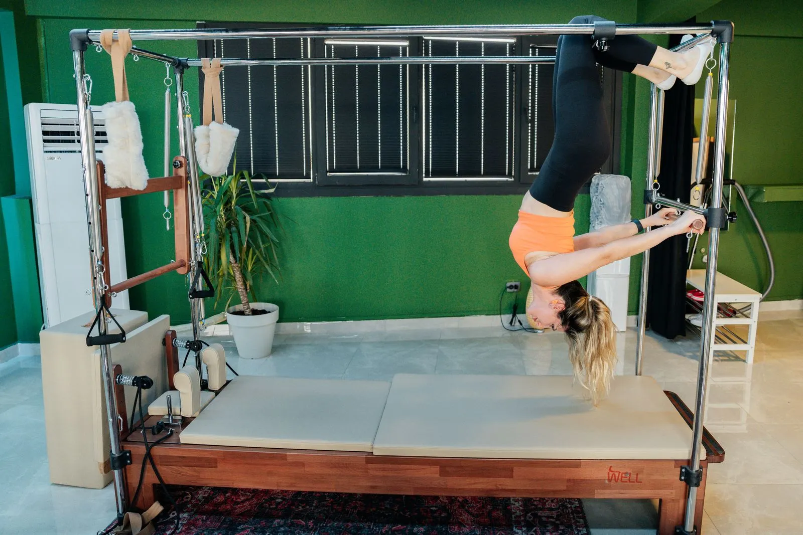 A woman exercising on a Pilates machine